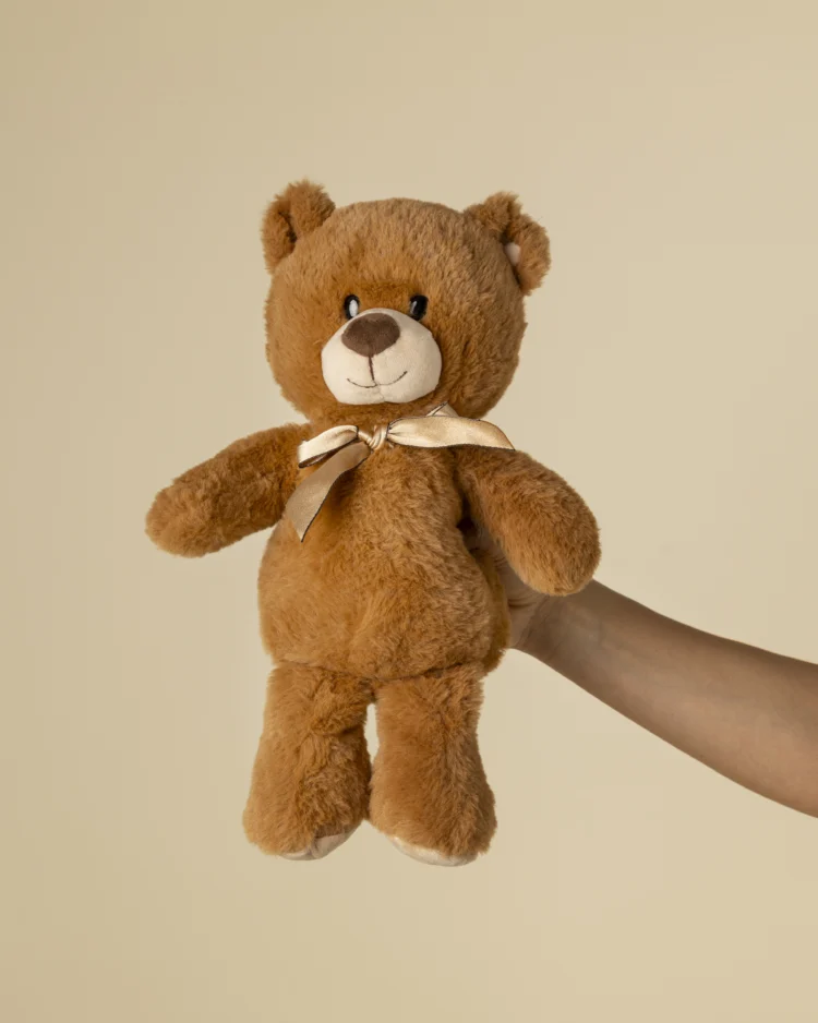 Brown teddy bear with bow