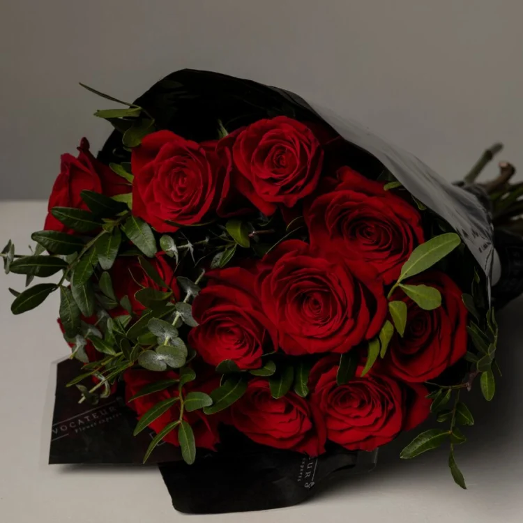 Bouquet of fresh red roses with greens