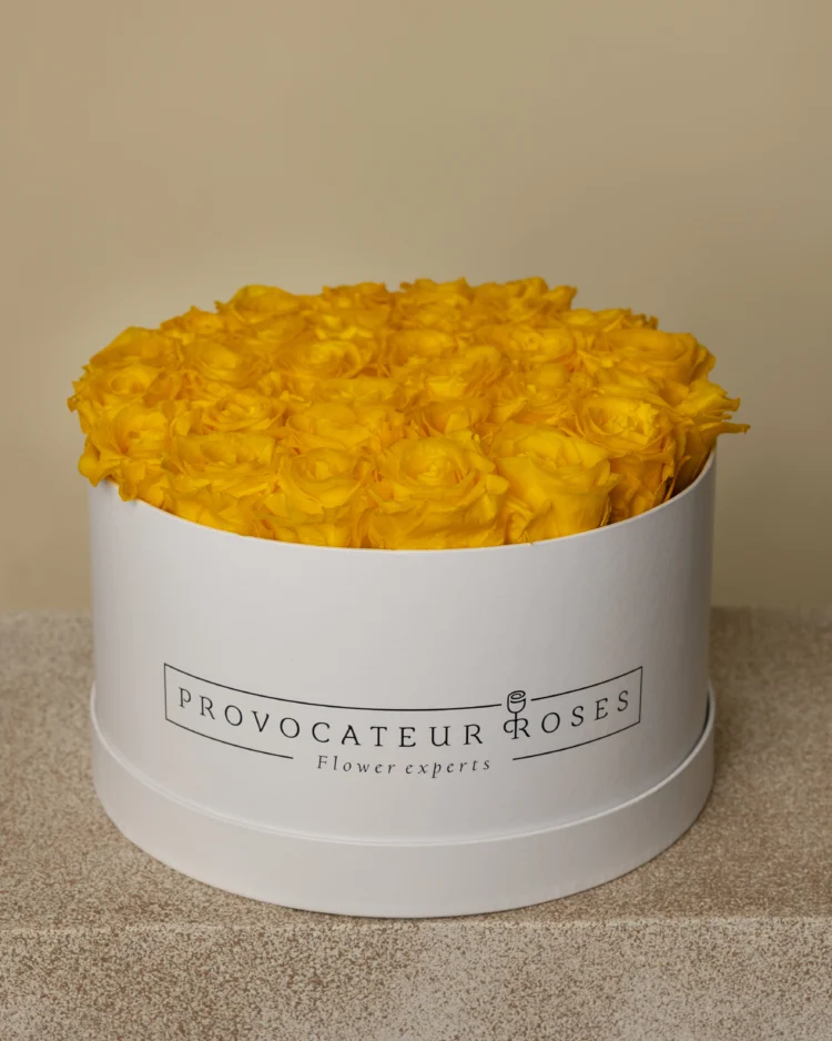 Round box of yellow preserved roses